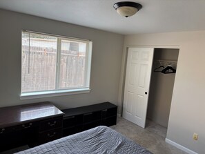 A bedroom with a bed, a dresser, a closet, and a window with blinds. - Quiet and comfortable house in Springfield. (Springfield)