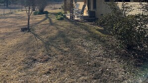 A house with a brick exterior, a metal roof, and a covered porch. - Lake Life is Calling! Minutes to Cypress Bend Park, private 5-Acre Retreat (Florien)