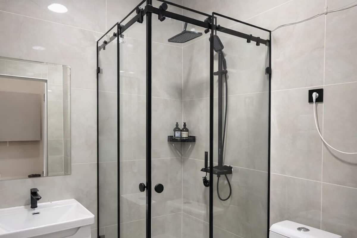 Shower, hair dryer, slippers, towels