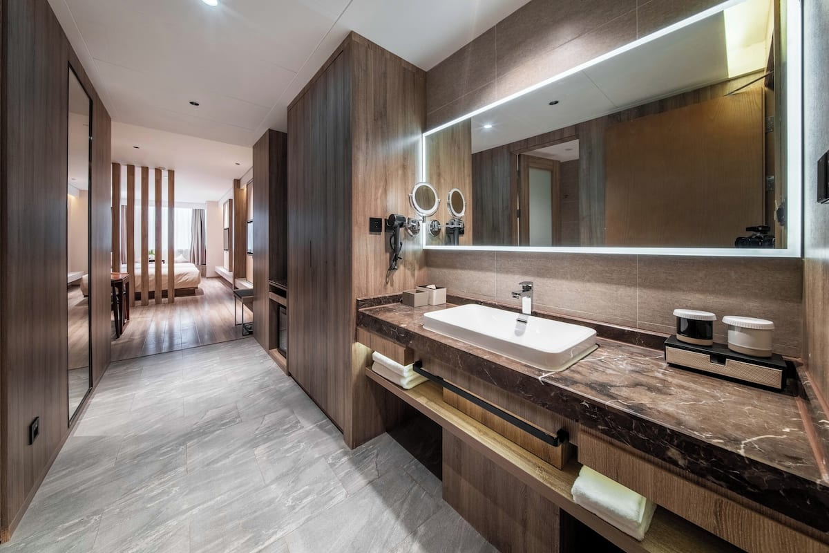 A modern bathroom with a large mirror, a sink, and a vanity.
