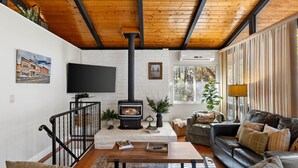 A cozy living room with a fireplace, a television, and comfortable seating.