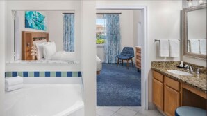 A hotel room with a large bathtub, a separate bathroom with a sink and mirror, and a view of the outside through a door. - Harborside Resort at Atlantis, Bahamas 2 Bedrm Lockoff Villa  7/24/26 - 7/31/26 (Paradise Island)