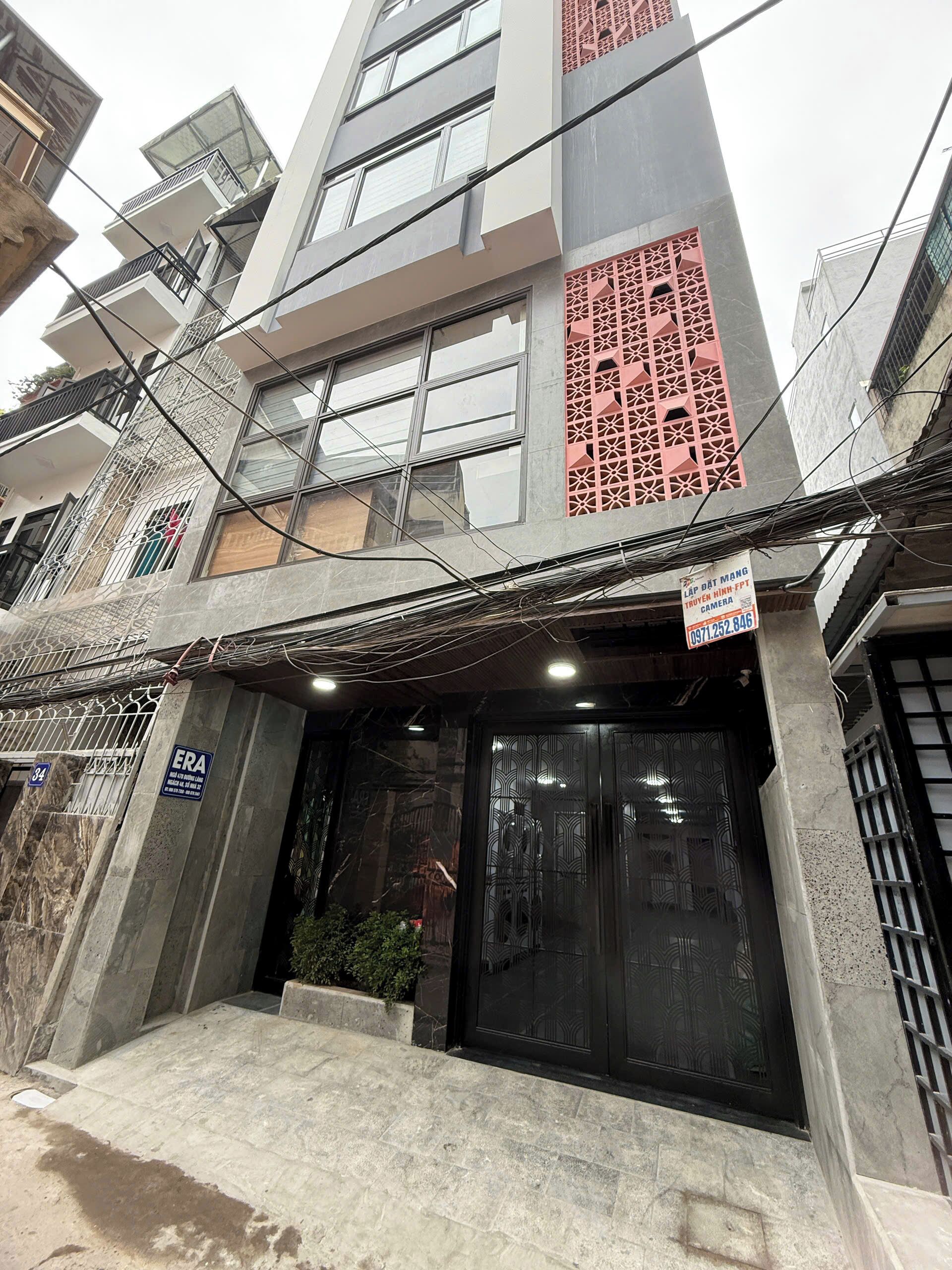 A multi-story building with a modern facade, including large windows and decorative panels.