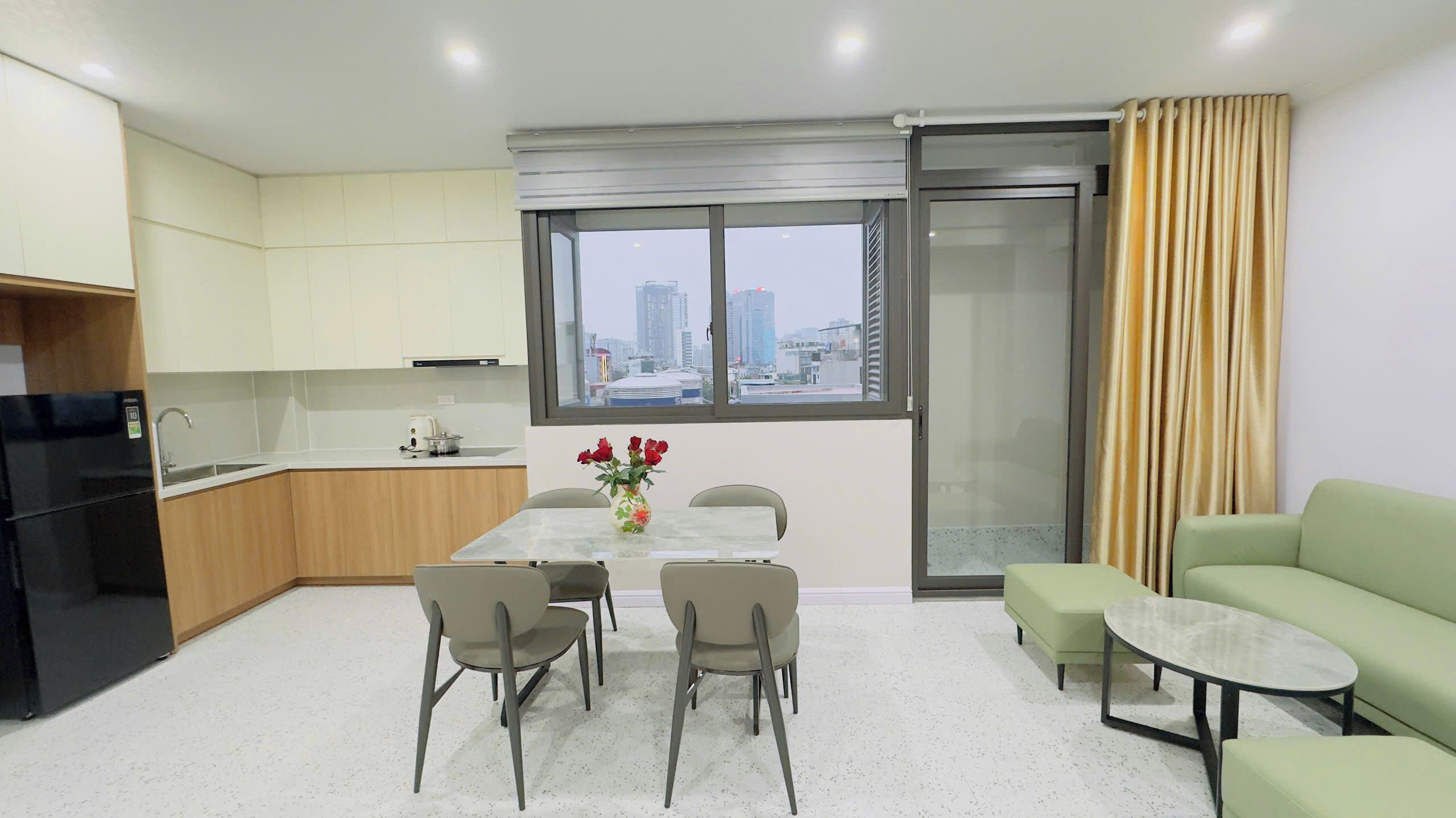 A modern apartment with a kitchen, dining area, and living space.