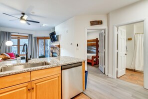 A kitchen with granite countertops, wooden cabinets, a dishwasher, and a ceiling fan. - Walk to Ski Lift & Hot Tubs! Mtn-View Keystone Gem (Keystone)