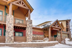 A lodge with a stone pillar, wooden balconies, and a sign reading "Hidden River Lodge". - Walk to Ski Lift & Hot Tubs! Mtn-View Keystone Gem (Keystone)