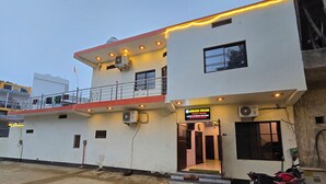 A two-story building with a sign for "Awadh Dhama Guest House" indicating availability. - Avadh Dham Guest House (Ayodhya)