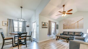 A spacious living area with a dining table, chairs, a sofa, and a ceiling fan. - Mtn Views & Hot Tub: Modern Gatlinburg Townhome (Gatlinburg)