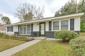 A single-story house with a front porch, a small front yard, and a driveway. - Sand Volleyball Court, Pool, Hot Tub! Fun Retreat (Savannah)