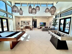 A spacious lobby with a pool table, seating area, and a television. - Luxury Townhome near Zion NP! Sleeps 21! Hot Tub! Resort Pool! Tesla Charging! (Washington)