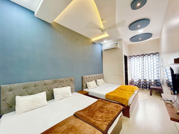 Deluxe Triple Room | Premium bedding, desk, laptop workspace, free WiFi - Hotel T P Inn near Mahakaleshwar Temple (Ujjain)