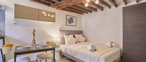 Desk, iron/ironing board, bed sheets