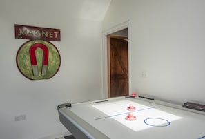 A pool table with a magnet sign and a door leading to another room. - Escape to coastal bliss at this stylish family retreat of Lower Hillcott (Bude)