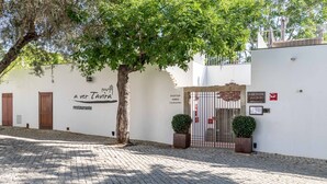 A building with a sign reading "A VER TAVIRA restaurant" and a gate labeled "ROOFTOP".