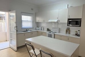 Fridge, microwave, oven, stovetop - Ground Floor Esplanade Oceanfront Apartment (Cronulla)
