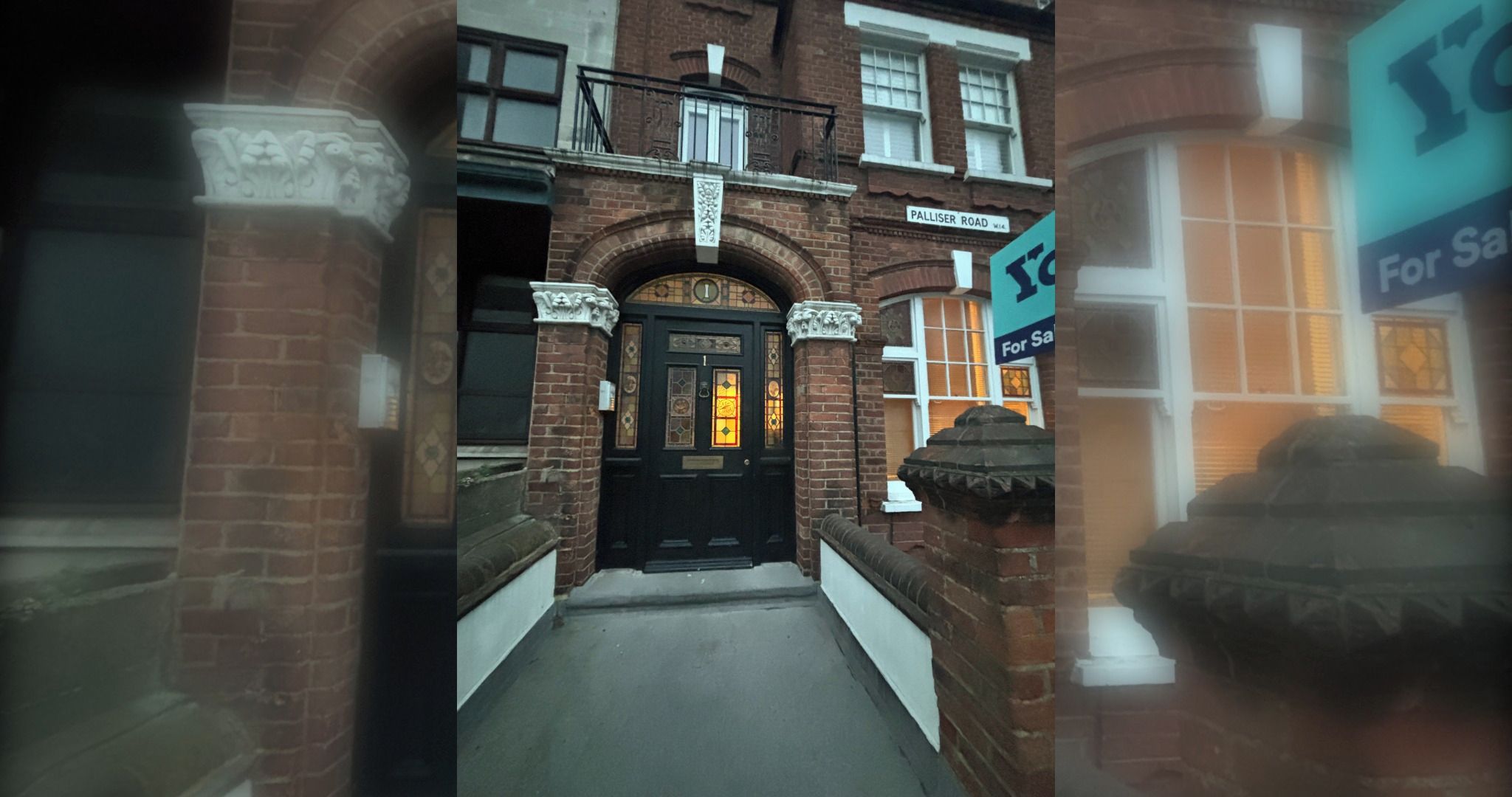 A brick building with a black door, a sign for Palliser Road, and a 'For Sale' sign.
