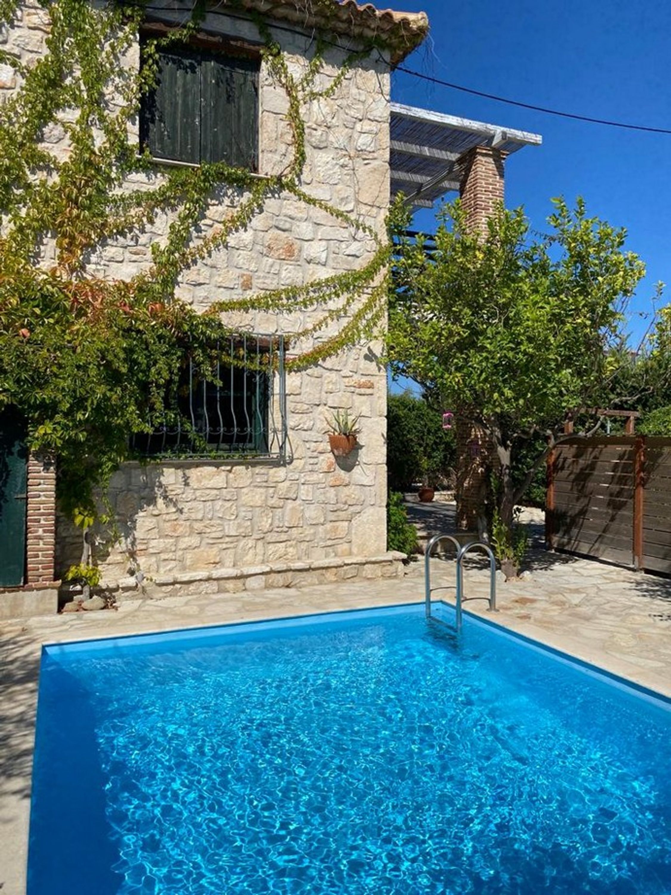 A stone building with a swimming pool.