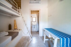 A narrow hallway with a staircase on the left, a bench on the right, and a bathroom visible through a doorway. - Trullo GiaMar · Private pool in olive grove, 3 bedrooms, dogs welcome · Ostuni (Ostuni)