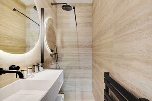 A modern bathroom with a large mirror, a white sink, and a shower area. - Amazing 2-bedroom apartment with AC in lively Paris (Paris)