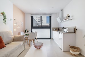 A modern apartment with a living area, dining space, and kitchenette. - Comfortable Studio "The Stairs" – Excellent Location, Perfect for Couples (Tarifa)