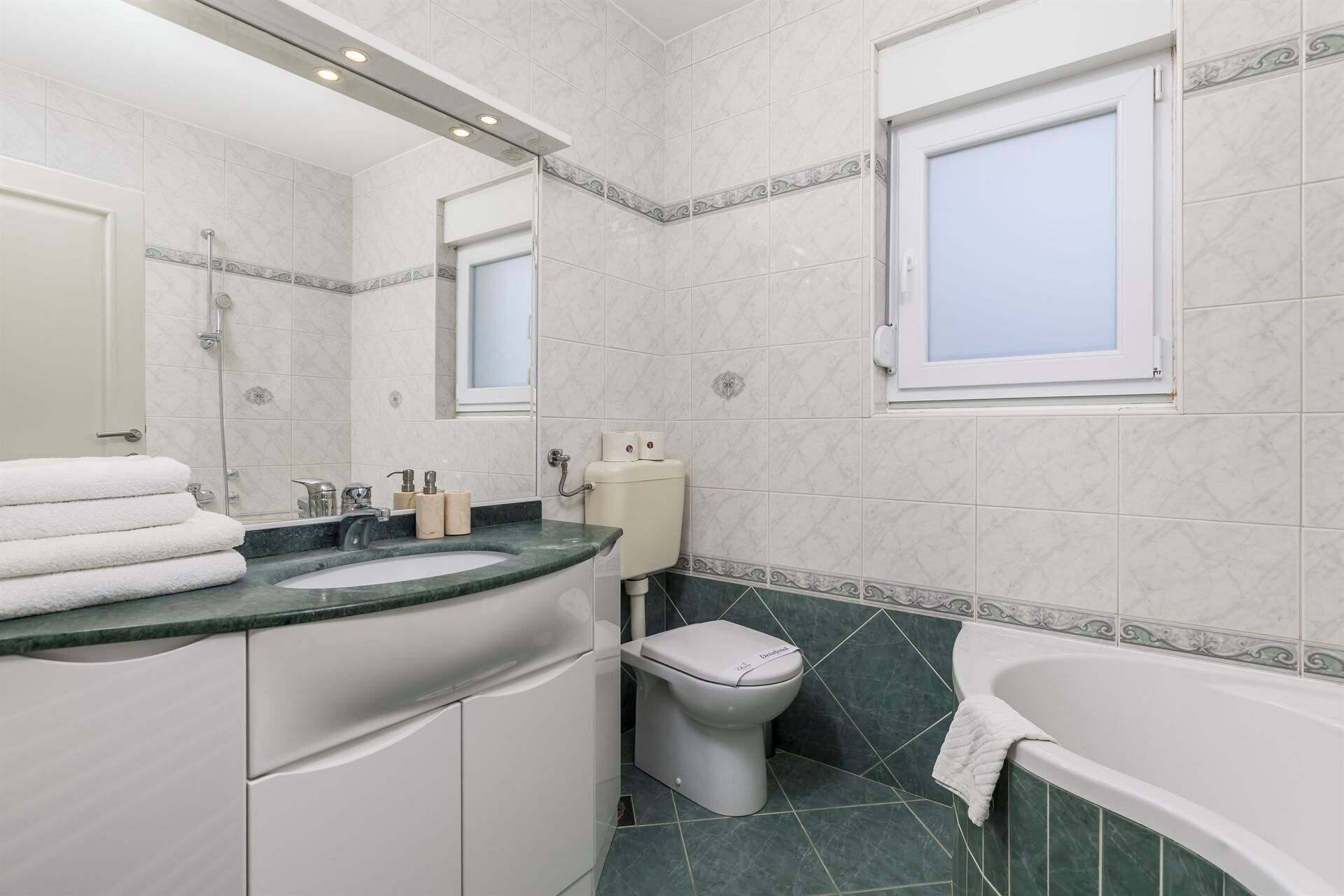A bathroom with a sink, toilet, and bathtub.