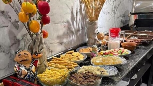 A buffet table with various food items and a decorative figure. - Welcome Inn Hotel (Tashkent)