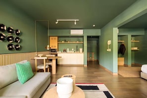 A modern living room with a sofa, a coffee table, and a dining area with a table and chairs. - HOM Tonala Bright 1 BR Apartment With Pool in Mexico City (Mexico City)