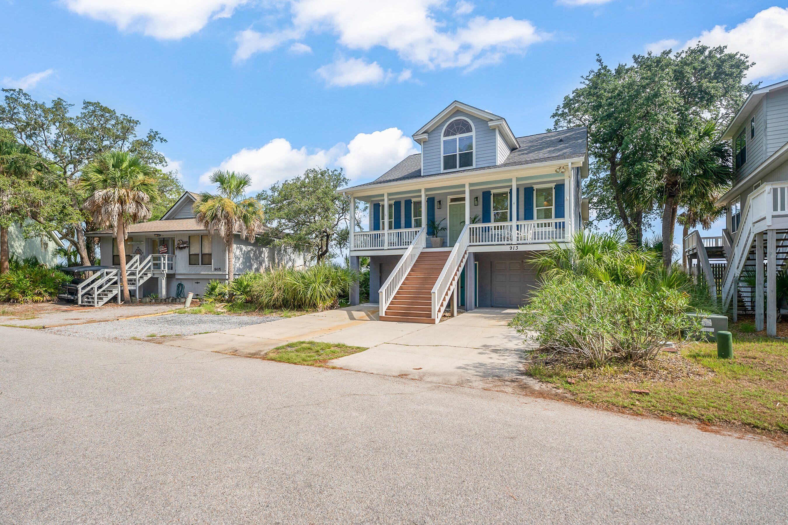 A two-story house with a front porch, a staircase, and a garage.
