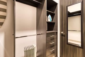 Ein modernes Badezimmer mit integrierter Dusche, Handtuchhalter und Spiegel.