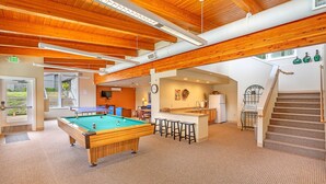 A pool table in a spacious room with wooden beams and a carpeted floor. - Aqua Vista Condo at Blue Heron Resort (Union)