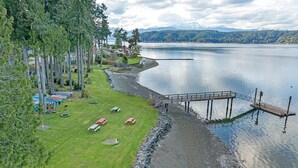 A lakeside property with a dock, picnic tables, and a stone wall along the water's edge. - Aqua Vista Condo at Blue Heron Resort (Union)