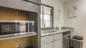 A modern kitchen with stainless steel appliances, a built-in oven, and a dishwasher. - 1 Mi to Graceland: Quiet Home w/ Private Yard (Memphis)