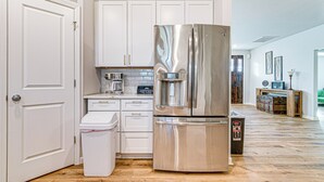 A modern kitchen with white cabinets, stainless steel appliances, and a wooden floor. - Artists Retreat w/ Deck! 5 Mi to Dtwn Durham (Durham)