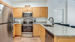 A kitchen with wooden cabinets, stainless steel appliances, granite countertops, and a dishwasher. - Walk to Ski Lift & Hot Tubs! Mtn-view Keystone Gem (Keystone)