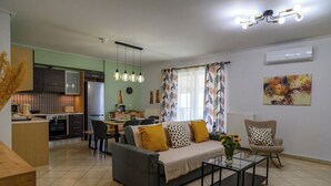 A modern apartment with a dining area, kitchenette, and living room. - Thyme Out - Modern Apartment in Egaleo/Athens (Egaleo)