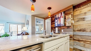 A modern kitchen with a large island, stainless steel appliances, and wooden accents. - Pool, Golf, Marina! Galena Territory Resort Home (Galena)