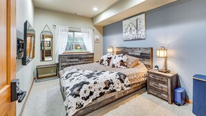 A bedroom with a bed, bedside tables, a mirror, a window with curtains, and a wall-mounted artwork. - Near Ferry, Shops & Eats! Anacortes Townhome (Anacortes)
