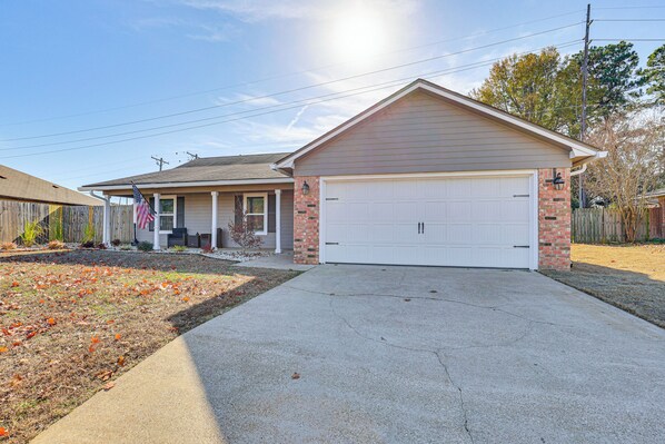 A two-story house with a garage, a front porch, and a brick exterior. - Hot Tub & Fire Pit: Home Near Downtown Texarkana (Texarkana)
