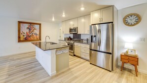A modern kitchen with stainless steel appliances, wooden cabinets, and a central island. - Newly Built Home w/ Yard, 4 Mi to Dtwn Caldwell! (Caldwell)