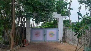 A gated entrance with a sign that reads "Hotel & Restaurant."