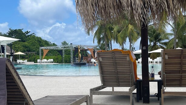 A beachside lounge area with lounge chairs, a pool, and a stage for events. - Studio with pool access and views of the Diamond Rock and Morne Larcher (Le Diamant)