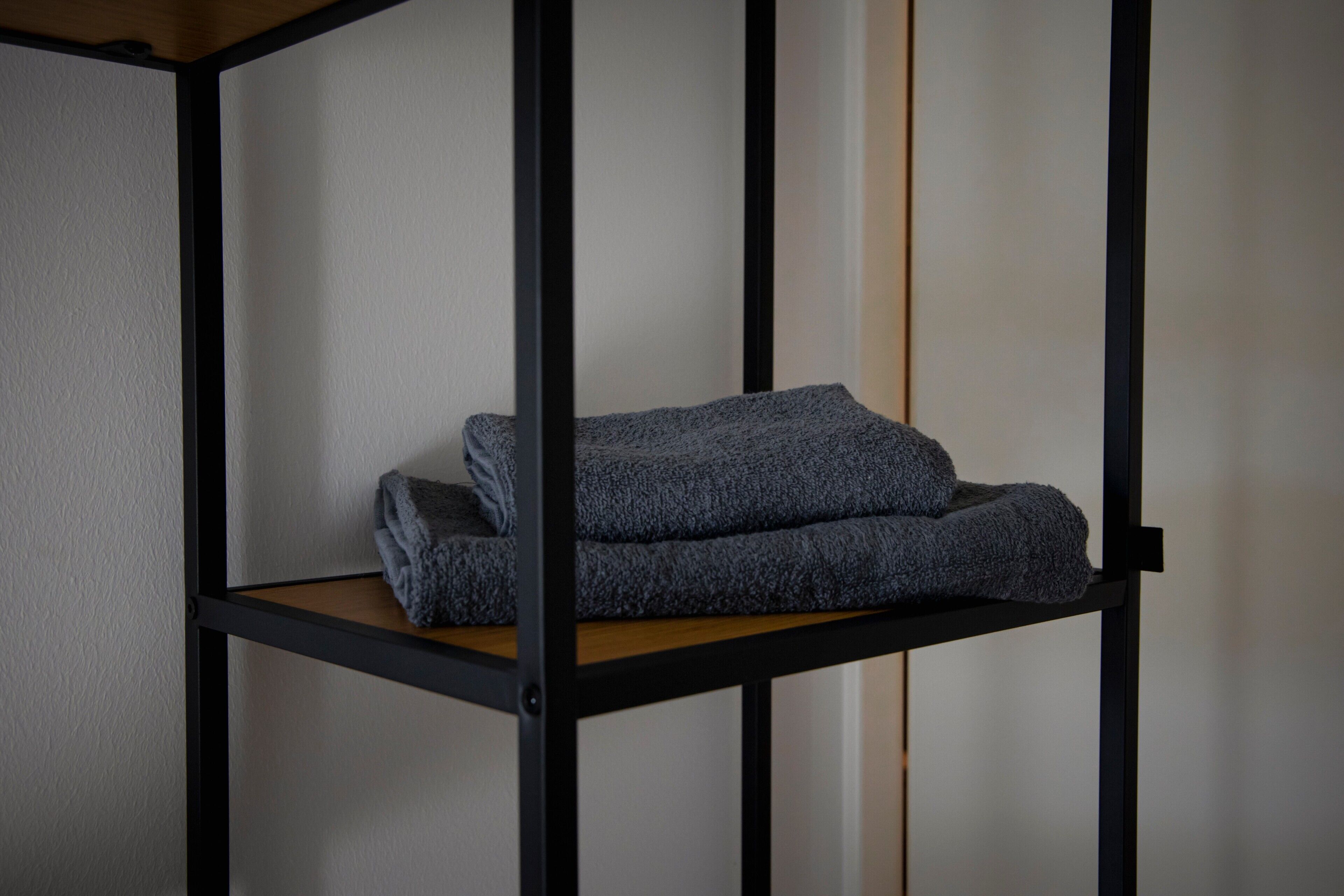 A bunk bed with a wooden platform and black metal frame.