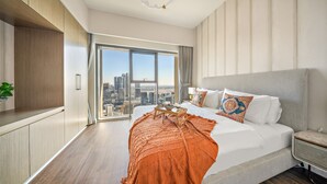 A modern hotel room with a large bed, a city view, and a minimalist design. - Downtown Dubai Chic 1BR Retreat (Dubai)