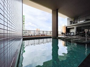A swimming pool with a view of the cityscape, a covered seating area, and a restaurant named 'Gourmet.' - Solaz by Hosppedar (João Pessoa)
