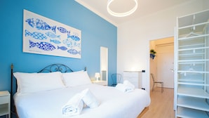 A bedroom with a bed, a nightstand, a chair, and a wardrobe. - Solemar Sicilia-Vista Mare Alla Cala  (Palermo)