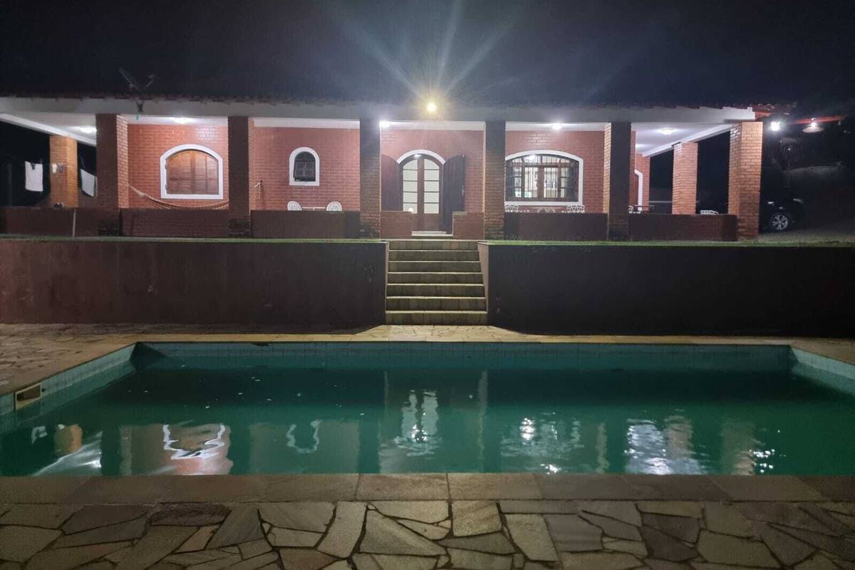 A brick building with a pool in front.