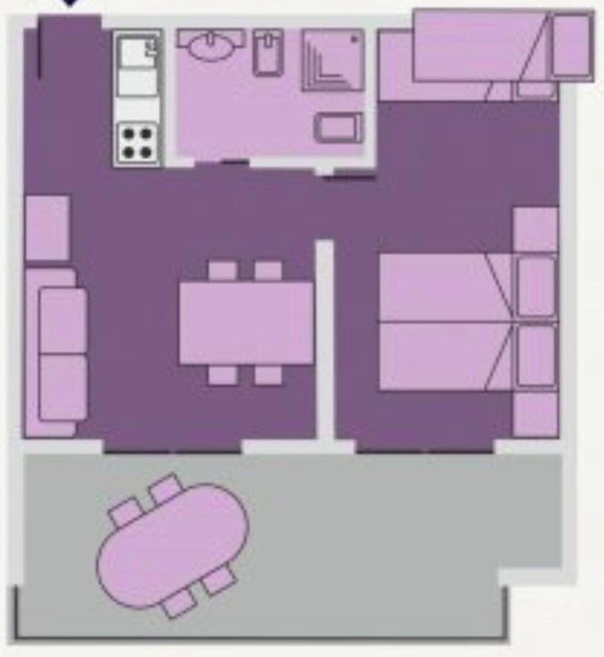 Ein Grundriss mit einer Küche, einem Essbereich und einem großen Bett.