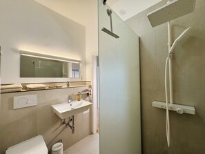 Shower, hair dryer, towels, toilet paper