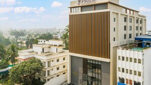 A modern building with a sign reading "PARK" and "CULT OF ANANYA GROUP". - Park Inn & Suites By Radisson, Puri (Puri)