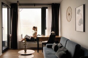 Apartamento superior, balcón, vistas al río | Zona de estar | Una televisión de pantalla plana